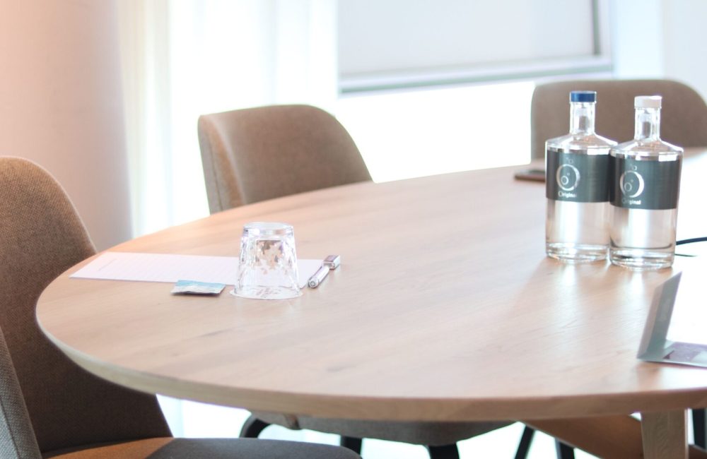 Elegant conference room featuring a wooden table and upholstered chairs, perfect for meetings.